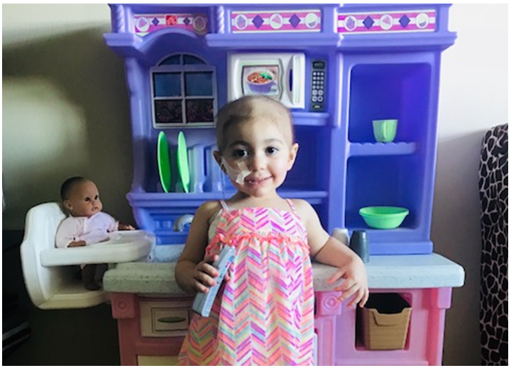 Carina, blood stem cell recipient, with her kitchen playset