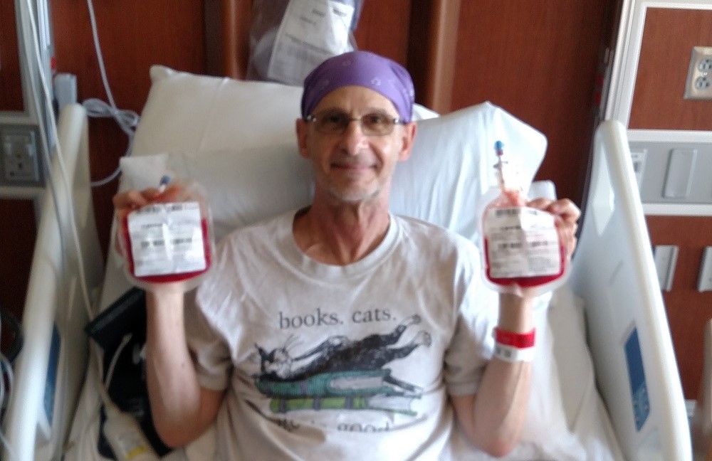 Steve holding his two bags of cord blood on transplant day