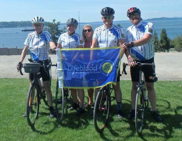 Seattle cyclists stop for a photo along the scenic route