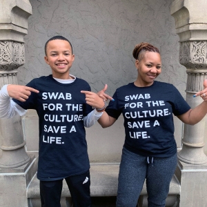Two people wearing t-shirts with the words culture save a life